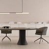 Modern dining table with chairs in a minimalistic room.