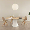 Modern dining table with chairs and a pendant light in a minimalistic setting
