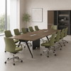Modern conference room with a long wooden table and green chairs.