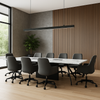 Modern conference room with a long table and gray chairs.