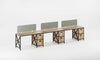 Long wooden desk with three screen panels on a white background