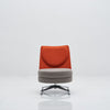 Modern chair with orange backrest and gray seat on a white background