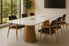 Modern conference room with a long white table and wooden chairs.
