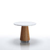 Small round table with a white top and brown ribbed base on a white background