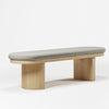 Modern bench with a wooden base and gray cushion on a white background