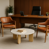 Modern office setup with wooden desk, leather chairs, and a round marble table.