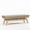Wooden bench with a textured cushion on a white background