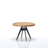 Round wooden table with black metal legs on a white background