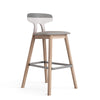 Bar stool with wooden legs and gray cushioned seat on a white background