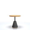 Small round table with a wooden top and gray cone-shaped base on a white background