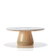 Round table with a marble top and wooden base on a white background